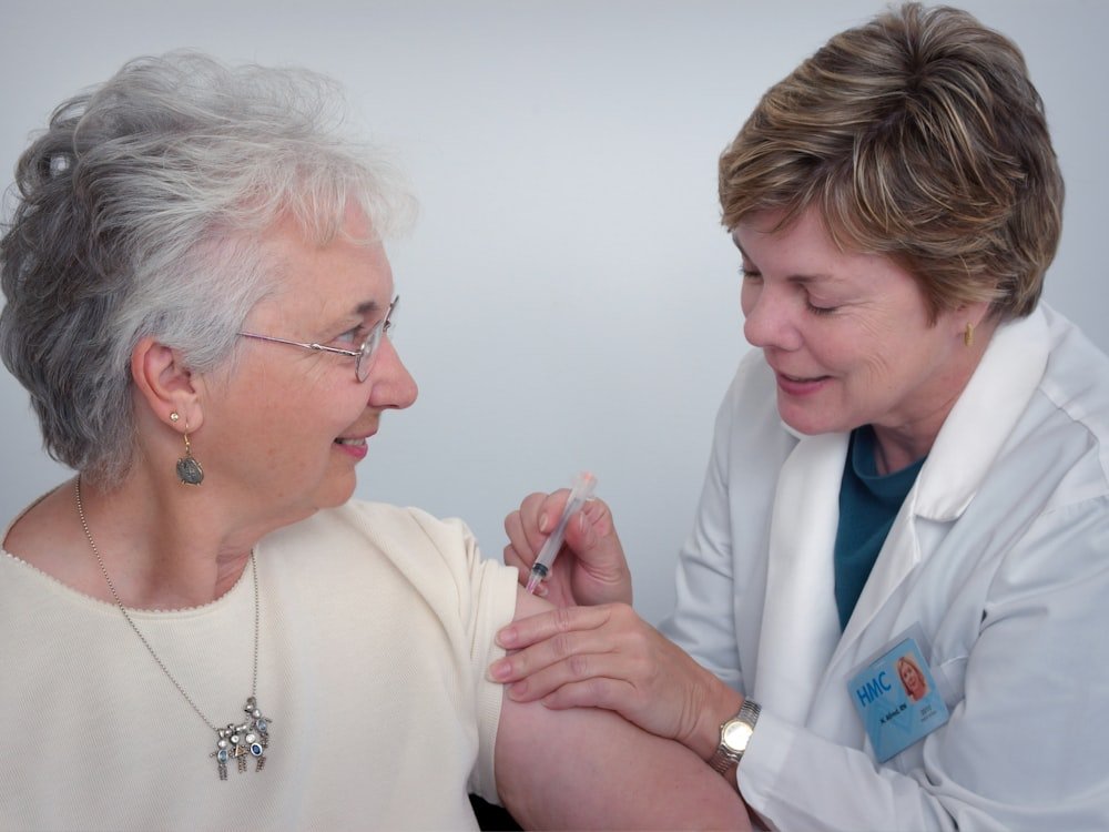 A nurse attending to an older patient